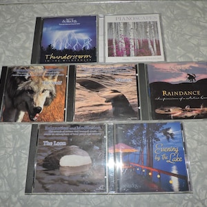 May include: A collection of eight audio CDs featuring nature sounds. The titles include "Thunderstorm in the Wilderness", "The Wolf", "Whales", "Raindance", "The Loon", "Evening by the Lake", and "Pianoscapes - The Beauty of Waterfalls".