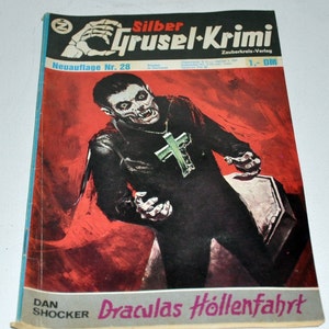 Puede incluir: Una portada de cómic vintage con un vampiro con un collar de cruz, un ataúd y el título "Draculas Höllenfahrt" en letras rojas y negras. El cómic se titula "Silber Grusel-Krimi" y es una "Neuauflage Nr. 28".
