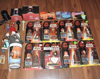 May include: A collection of Star Wars Episode I action figures in their original packaging. The figures include Darth Maul, Qui-Gon Jinn, Obi-Wan Kenobi, Jar Jar Binks, and more. The packaging features the Star Wars logo and the Episode I title.