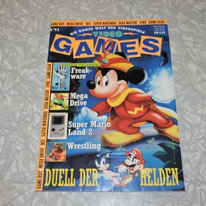 May include: A magazine cover for Video Games, issue 1/93, featuring a cartoon image of Mickey Mouse in a red and yellow costume. The cover text reads "Video Games" and "Duell der Helden".