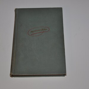 May include: A closed, hardback book with a grey cover. The title "My Friend's Wishes" is written in cursive within a red oval on the cover. The book is set against a white background.