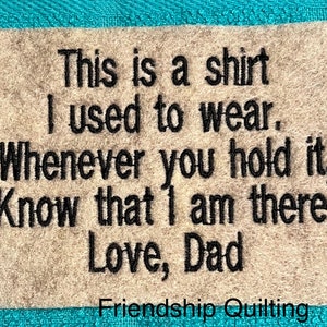 May include: A beige fabric square with black embroidered text that reads: "This is a shirt I used to wear. Whenever you hold it, Know that I am there. Love, Dad" and "Friendship Quilting".