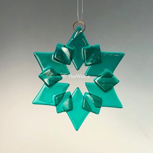 May include: Teal blue glass snowflake ornament with a gold loop for hanging.