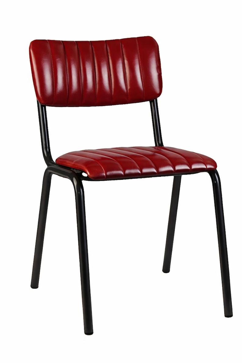 May include: A red, padded chair with a black metal frame. The chair features a rectangular back and a seat with horizontal stitching. The legs are angled for stability. The chair's dimensions are suitable for a dining or kitchen setting.