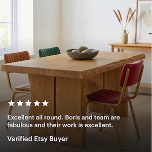 May include: A rustic wooden dining table with a natural finish, accompanied by chairs with red, orange, and green velvet seats and gold metal frames. A dark bowl with stones is on the table. The text reads: Excellent all round. Verified Etsy Buyer.