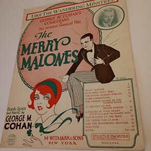 May include: Vintage sheet music cover for "The Merry Malones," a musical play by George M. Cohan. The cover features illustrations of a man in a tuxedo and a woman with red hair, along with song titles and the publisher's name.