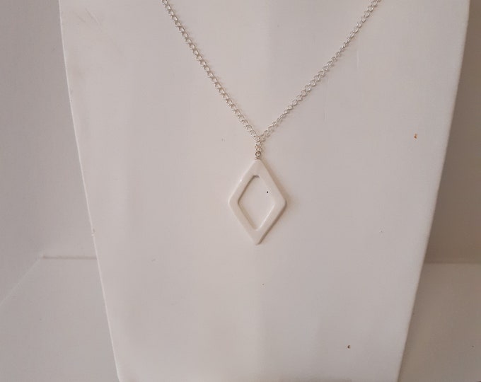 White long open diamond shaped porcelain pareal on a real silver necklace