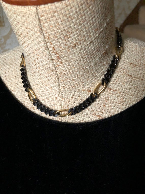 Elegantly assertive Monet black and gold-tone chai