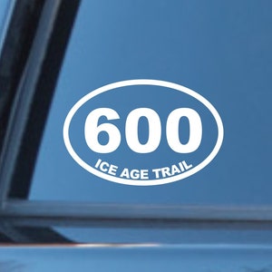 May include: White oval sticker with the number 600 and the text "ICE AGE TRAIL" on a blue car window.