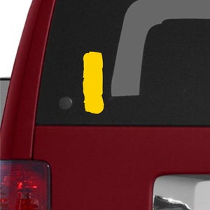 May include: A red Jeep with a yellow sticker on the back window.