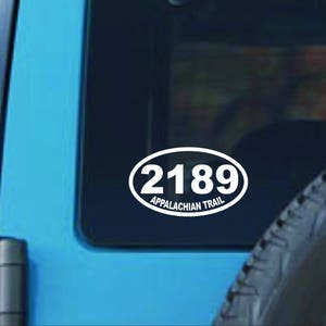 May include: White oval sticker with the text "2189 Appalachian Trail" on a blue car.