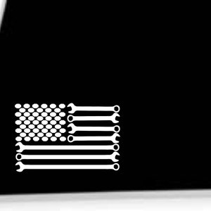 May include: White vinyl decal of an American flag made of wrenches. The flag is made of a white dotted background with white wrenches forming the stripes.