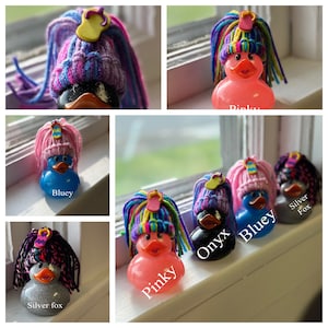 rubber ducks made with hair and flip flop on top