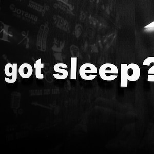 May include: A black and white image with the text "got sleep?" in white letters on a black background.
