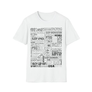 May include: White t-shirt with a black word cloud design featuring terms related to sleep disorders, including parasomnia, sleep apnea, insomnia, narcolepsy, sleep study, and more.