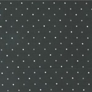 May include: A black fabric with a white polka dot pattern.