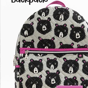 May include: The Archie Backpack, a gray quilted backpack with a repeating pattern of black bear faces. The backpack has a pink zipper and handle, with the text "KNOT + THREAD design" on a pink label.