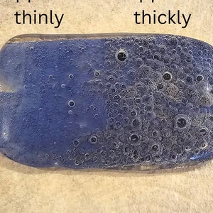 May include: A rectangular, blue object with rounded edges, showing the effects of thin and thick application. The text "Applied thinly" and "Applied thickly" is visible on the image. The thick application side has many bubbles.