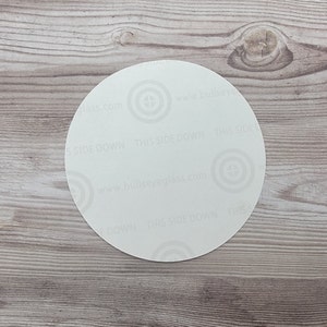 May include: White round sticker with the text "This Side Down" repeated around the edge. The text "www.bullseyeglass.com" is printed in the center.