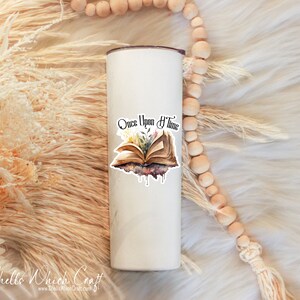 May include: White stainless steel tumbler with a vinyl decal of an open book with flowers and the text "Once Upon a Time".