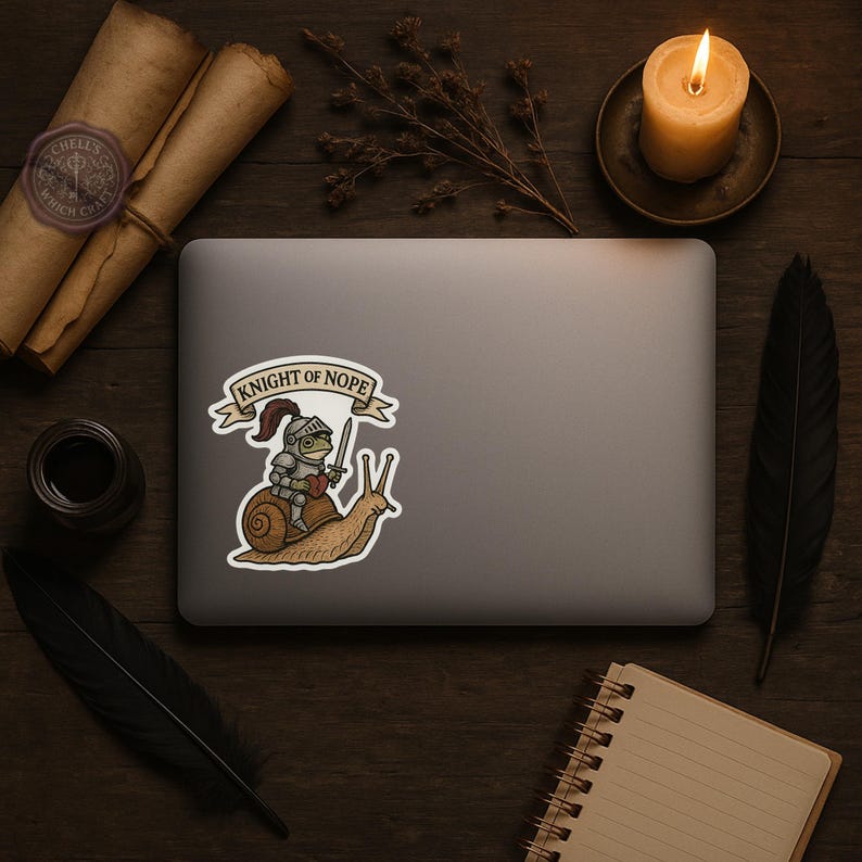 May include: A sticker featuring a cartoon knight riding a snail, with the text "KNIGHT OF NOPE" on a banner. The knight is wearing armor and holding a sword. The snail is brown and the knight is green. The sticker is on a laptop.