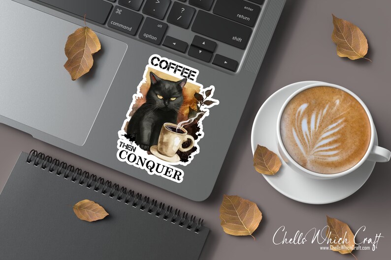 May include: A black cat with green eyes sits with a steaming cup of coffee. The cat is surrounded by a watercolor background with fall leaves. The text "Coffee Then Conquer" is written below the cat.