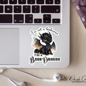 May include: A black and gold book dragon sticker with the text "I'm not a bookworm, I'm a book dragon".
