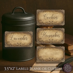 May include: A black metal canister with a handle, featuring a label that reads "Lavender." Beside it are three decorative labels, one labeled "Cookies," another "Keepsakes," and a blank one. The labels are 3.5" x 2" and have an antique design.