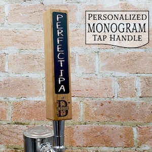 May include: A wooden beer tap handle with a black chalkboard insert that says "PERFECT IPA". The handle is personalized with the letter "B" and the word "BLASCHKA" in a decorative font.