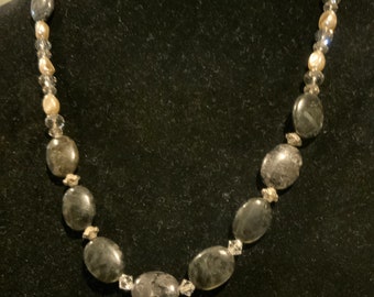 Semi precious stones, pearls and crystals.  Made by sister Carol