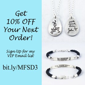 May include: Silver pendant necklaces and bracelets. One necklace has a cocktail design, the other has handwriting that says "with much love, John D". Bracelets have black braided bands and engraved silver bars with coordinates and text.