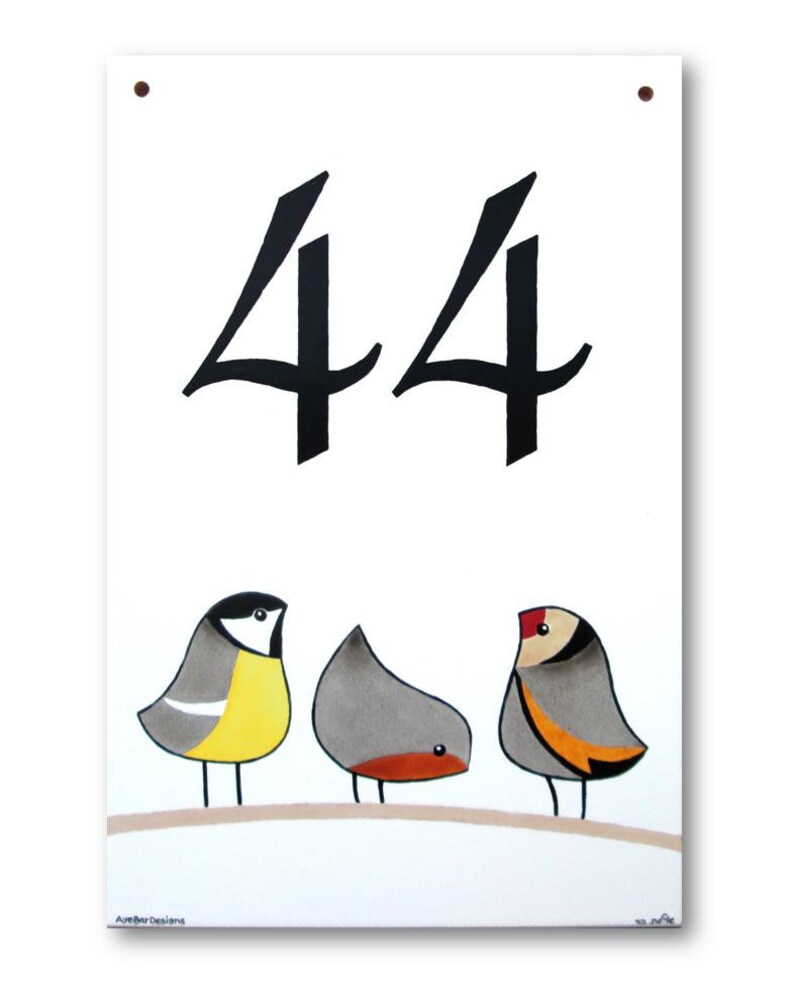 Op de afbeelding: Een wit keramisch huisnummerbord met het nummer 44 in zwarte schrijfletters. Drie cartoonvogels zitten op een tak aan de onderkant van het bord. De vogels zijn geel, grijs en grijs met oranje accenten.