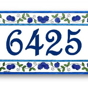 May include: Blue and white ceramic house number sign with a blueberry design. The number 6425 is displayed in a blue cursive font.