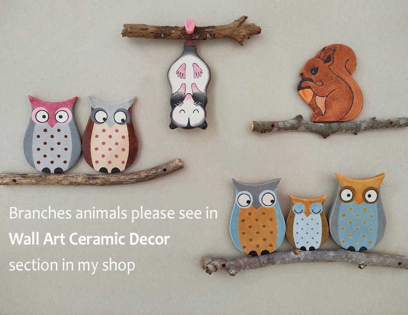 May include: Ceramic wall art featuring a variety of animals, including owls, a squirrel, and a sugar glider. The animals are painted in bright colors and are attached to wooden branches. The text "Branches animals please see in Wall Art Ceramic Decor section in my shop" is visible at the bottom of the image.