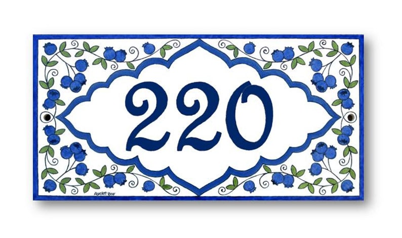 May include: A white ceramic house number sign with a blue border and blueberry design. The number 220 is displayed in a blue font.