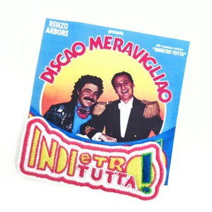 May include: A red and yellow embroidered patch with the text "INDIETRO TUTTA!" in white. The patch is on a blue background with a yellow circle around the text. The patch is from a vintage Italian record album featuring Renzo Arbore.