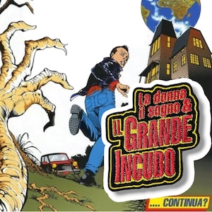 May include: A red and yellow embroidered patch with the text "La donna il sogno & IL GRANDE INCUBO" and the text "...CONTINUA?" below. The patch is on a white background.