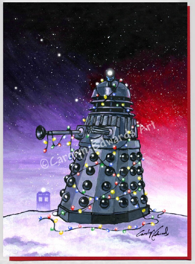 May include: A festive Christmas card featuring a Dalek decorated with colourful Christmas lights and a TARDIS in the background. The card is signed "Carly Edwards Art".