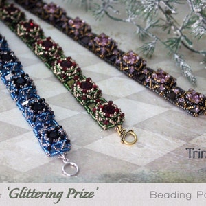 May include: Three beaded bracelets in blue, green, and purple with silver and gold accents. The bracelets are on a white and gray tiled surface. The text 'Glittering Prize' and 'Beading Pattern' is visible below the bracelets.