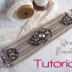 May include: A silver beaded bracelet with a large crystal centerpiece and smaller crystals and pearls. The bracelet is on a white background with the text "Victorian Bracelet Tutorial" in pink.