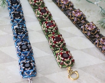 May include: Three beaded bracelets featuring intricate woven patterns with central faceted stones. The left bracelet is blue and black with a silver-tone toggle clasp. The center is green and red with a gold-tone clasp. The right is purple and black.