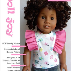 May include: A PDF sewing pattern for a flutter-sleeve top designed to fit 18-inch dolls. The pattern includes instructions for a round neckline and flutter sleeves. The image shows a doll wearing the finished top, which is white with a floral print and pink ruffles.