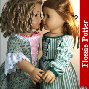 May include: Two 18-inch dolls wearing matching dresses. The doll on the left is wearing a green dress with pink accents and white lace trim. The doll on the right is wearing a green and white striped dress. The dolls are looking at each other and holding hands. The image is titled "Sisters" and "Flossie Potter".