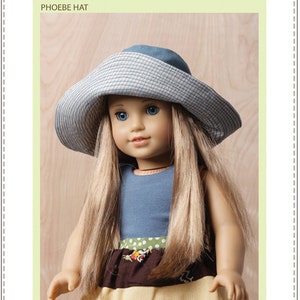 May include: A sewing pattern for an 18-inch doll hat. The pattern is called "Phoebe Hat" and is by Bonjour Teaspoon. The image shows a doll wearing the hat, which is blue and white checkered.