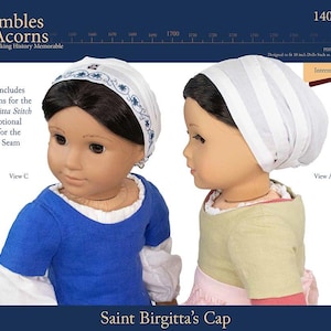 May include: Two dolls wearing Saint Birgitta's caps. One doll is wearing a blue shirt and a white cap with blue floral embroidery. The other doll is wearing a light green shirt and a white cap with vertical stripes. The image includes text that says "Thimbles and Acorns" and "Saint Birgitta's Cap".