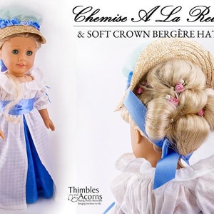 May include: A doll wearing a white and blue dress with a blue sash and a straw hat with a blue ribbon. The doll is wearing a hairstyle with pink flowers and pearls. The text "Chemise A La Reine & SOFT CROWN BERGERE HAT" is above the doll.