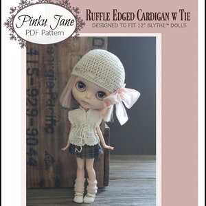 May include: A crochet pattern for a ruffle edged cardigan with a tie designed to fit 12 inch Blythe dolls. The pattern is easy level and includes a photo of a doll wearing the cardigan.