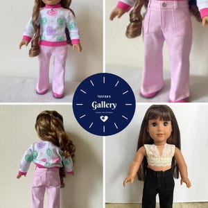 May include: Two dolls wearing different outfits. The doll on the left is wearing a pink and white sweater with a heart pattern and pink pants. The doll on the right is wearing a white lace top and black pants.