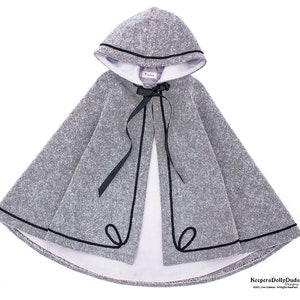 May include: A gray hooded cape with a black trim and a black ribbon tie. The cape is lined with white fabric.