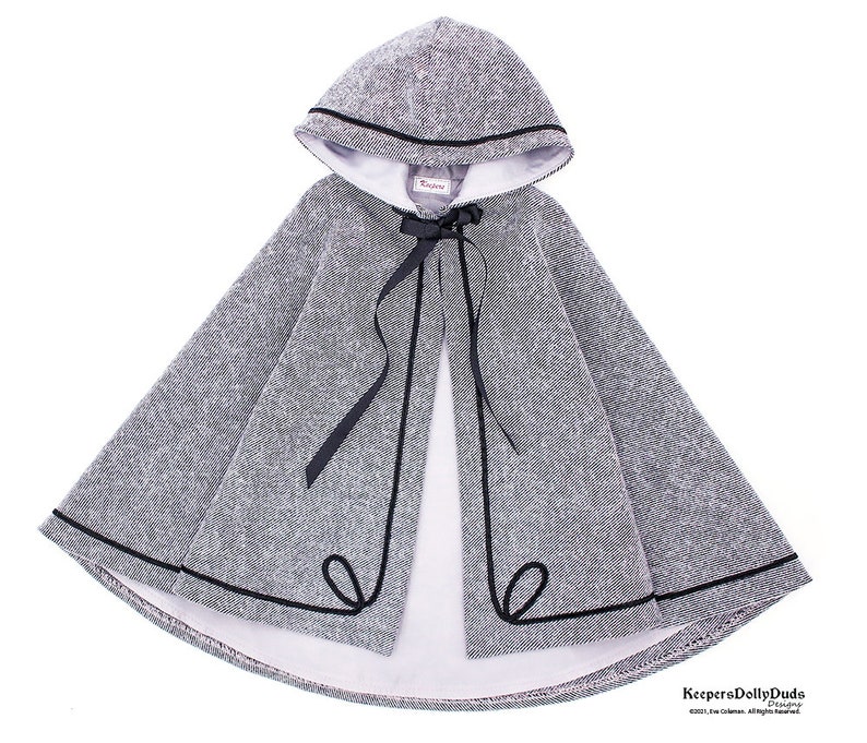 May include: A gray hooded cape with a black trim and a black ribbon tie. The cape is lined with white fabric.